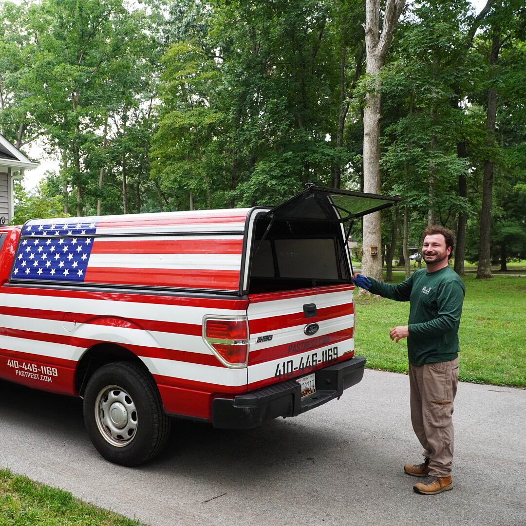 Erik Pasternack, founder of Pasternack Pest Management, at his flag-wrapped service truck